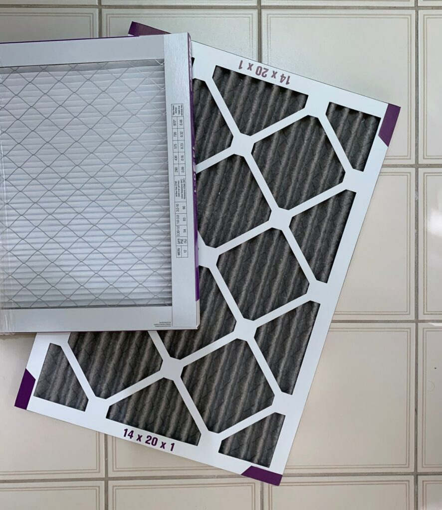 A dirty furnace filter and a clean furnace filter side by side.