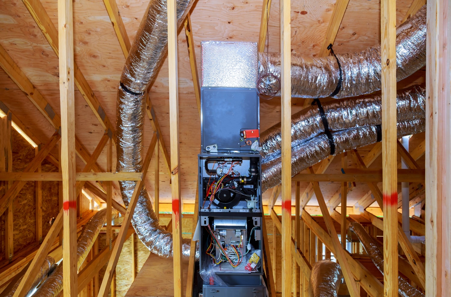 A furnace being installed in a home's attic.