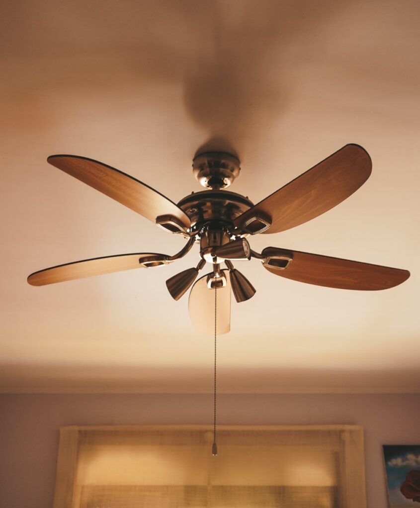 A wooden ceiling fan inside a home.