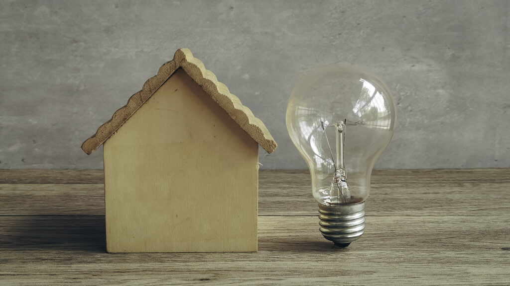 A house with a lightbulb next to it.